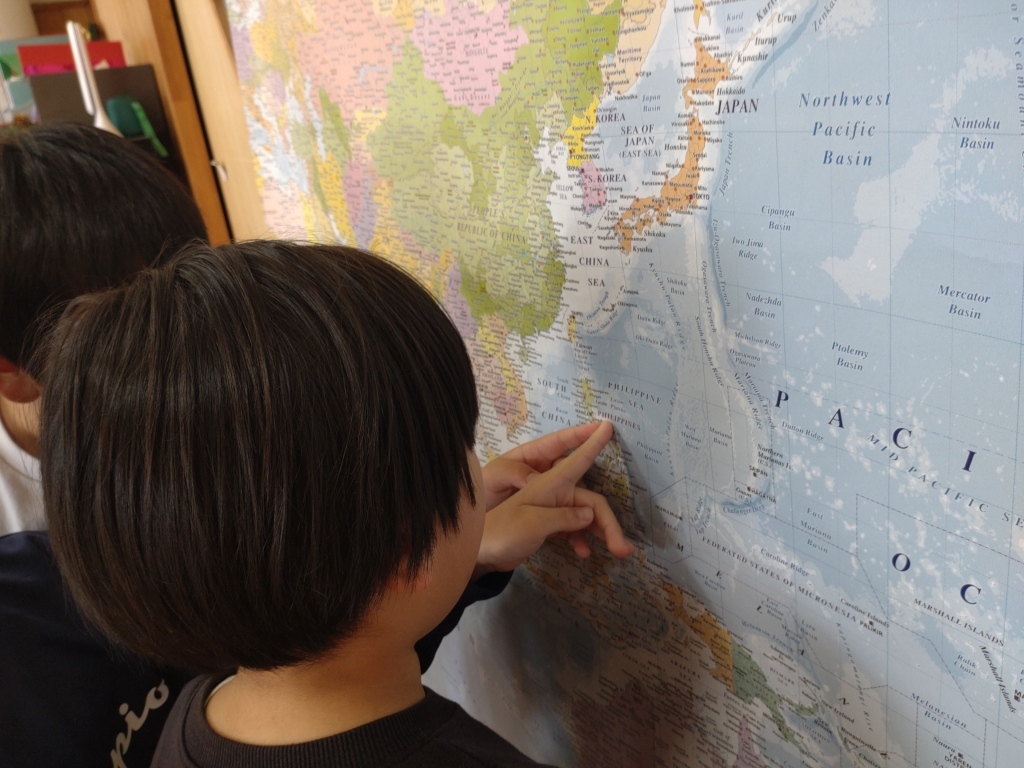 kids checking the Philippines on the map